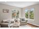 Comfortable sitting room with armchairs and bright windows offering lots of natural light at 3315 Klondike Pl, Castle Rock, CO 80108
