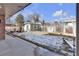 Picturesque backyard with a storage shed and a partial snow cover at 13957 E Louisiana Pl, Aurora, CO 80012