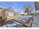 Cozy backyard with a built-in grill area, a mix of grass and a touch of winter snow at 13957 E Louisiana Pl, Aurora, CO 80012