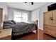 Bedroom features a window with blinds, wood floors, and an ample closet with white doors at 13957 E Louisiana Pl, Aurora, CO 80012