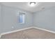 Bedroom featuring carpet, light grey walls and a window at 13957 E Louisiana Pl, Aurora, CO 80012