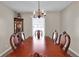 Dining room featuring an ornate wood table, chandelier, and bright window at 13957 E Louisiana Pl, Aurora, CO 80012