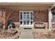 Close-up of a front porch that leads up to a white door with glass panels and sidelights at 13957 E Louisiana Pl, Aurora, CO 80012