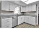 Modern kitchen with white cabinets, stainless steel appliances, and gray countertops at 13957 E Louisiana Pl, Aurora, CO 80012