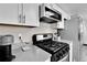 Well-equipped kitchen with stainless steel appliances and sleek, black stovetop at 13957 E Louisiana Pl, Aurora, CO 80012