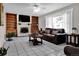 Cozy living room with built-in bookshelves, fireplace, and plush seating at 13957 E Louisiana Pl, Aurora, CO 80012