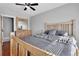 Comfortable main bedroom featuring natural wood furniture and a ceiling fan at 13957 E Louisiana Pl, Aurora, CO 80012