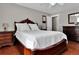 Main bedroom features beautiful wood furniture, hardwood floors, and natural light at 13957 E Louisiana Pl, Aurora, CO 80012