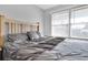 Bright main bedroom showcasing a comfortable bed and natural light from the windows at 13957 E Louisiana Pl, Aurora, CO 80012