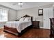 Main bedroom features beautiful wood furniture, hardwood floors, and natural light at 13957 E Louisiana Pl, Aurora, CO 80012