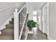 Carpeted staircase with white railing and plant; view of the hardwood floors and white trim at 13957 E Louisiana Pl, Aurora, CO 80012