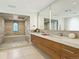 Modern bathroom with double sinks, a large shower, and wood cabinets at 21 S Kearney St, Denver, CO 80224