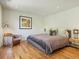 Comfortable bedroom with king-size bed and hardwood floors at 21 S Kearney St, Denver, CO 80224