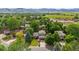 Stunning aerial view of a home surrounded by lush greenery and with mountain views at 5971 Windy St, Golden, CO 80403