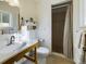 Well-lit bathroom with a wood framed sink vanity and a tiled walk-in shower at 5971 Windy St, Golden, CO 80403