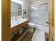 Modern bathroom featuring a wood framed sink vanity with a tub and shower combo at 5971 Windy St, Golden, CO 80403