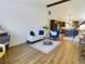 Open concept living space with wood floors, a large sofa, and view into the adjacent kitchen at 5971 Windy St, Golden, CO 80403