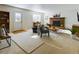 Cozy living room featuring a brick fireplace, natural lighting, and comfortable seating and decor at 5971 Windy St, Golden, CO 80403