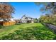 Spacious backyard with lush green grass, a trampoline, and a storage shed at 8288 W Chestnut Ave, Littleton, CO 80128