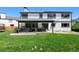 Backyard view with a covered patio, hot tub, and lush green lawn at 8288 W Chestnut Ave, Littleton, CO 80128