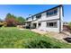 Expansive backyard featuring a well-maintained lawn and a covered patio area at 8288 W Chestnut Ave, Littleton, CO 80128