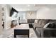 The finished basement has a comfy sectional couch and large flatscreen television at 8288 W Chestnut Ave, Littleton, CO 80128
