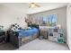 This bedroom features a charming bed with drawers and view from the window at 8288 W Chestnut Ave, Littleton, CO 80128