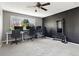 This bedroom features gray walls, a ceiling fan, and a built-in home gym area at 8288 W Chestnut Ave, Littleton, CO 80128