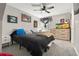 Cozy bedroom with a black comforter, neutral walls, and sneaker wall art at 8288 W Chestnut Ave, Littleton, CO 80128