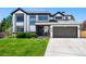 Charming two-story home with a well-maintained front yard and a two-car garage at 8288 W Chestnut Ave, Littleton, CO 80128