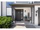 Inviting front porch with seating area and well-manicured landscaping at 8288 W Chestnut Ave, Littleton, CO 80128