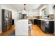 Modern kitchen with stainless steel appliances, white cabinets, and center island with seating at 8288 W Chestnut Ave, Littleton, CO 80128