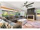 Inviting living room features a fireplace and a large window with a view of the backyard at 8288 W Chestnut Ave, Littleton, CO 80128