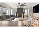 Inviting living room with large sectional sofa, fireplace and large windows offering plenty of natural light at 8288 W Chestnut Ave, Littleton, CO 80128