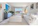 Bright living room with large windows, plush seating, and neutral decor at 8288 W Chestnut Ave, Littleton, CO 80128