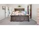 The main bedroom features a rustic wood bed frame and doorway access at 8288 W Chestnut Ave, Littleton, CO 80128