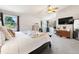 The spacious main bedroom includes bright natural light, a ceiling fan, and wood furniture at 8288 W Chestnut Ave, Littleton, CO 80128