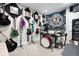 Creative music room with multiple guitars on display and a drum kit at 8288 W Chestnut Ave, Littleton, CO 80128