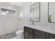 Modern bathroom with a tiled shower, marble floors, and a dark vanity with double sinks at 1308 Snowberry Ln # 301, Louisville, CO 80027
