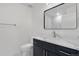 Contemporary bathroom with a dark vanity, marble floors, and sleek fixtures at 1308 Snowberry Ln # 301, Louisville, CO 80027