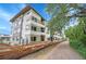 Contemporary three-story apartment complex with wooden fence and pathway, showing multiple units and balconies at 1308 Snowberry Ln # 301, Louisville, CO 80027