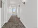 Hallway with gray patterned carpet featuring lighting fixtures, doors, and an exit at 1308 Snowberry Ln # 301, Louisville, CO 80027