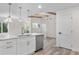 Modern kitchen with stainless steel appliances, white cabinets, quartz countertops, and hardwood floors at 1308 Snowberry Ln # 301, Louisville, CO 80027