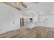 Open-concept living space with light wood floors, recessed lighting, an open kitchen area, and exposed beams at 1308 Snowberry Ln # 301, Louisville, CO 80027