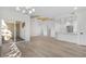 Spacious living room features light wood floors, recessed lighting, with access to a private balcony and open kitchen area at 1308 Snowberry Ln # 301, Louisville, CO 80027