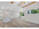Bright living room showcases light wood floors, recessed lighting, exposed beams, and access to open kitchen and large windows at 1308 Snowberry Ln # 301, Louisville, CO 80027