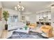 Bright living room showcases stylish furnishings and an open concept design flowing into the kitchen and dining area at 1308 Snowberry Ln # 301, Louisville, CO 80027