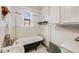 Bathroom with clawfoot tub and tiled walls at 215 E 11Th Ave # C3, Denver, CO 80203