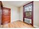 Cozy bedroom featuring hardwood floors and natural light from a large window at 215 E 11Th Ave # C3, Denver, CO 80203