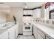 Bright kitchen featuring white cabinetry, tiled countertops, and modern appliances at 215 E 11Th Ave # C3, Denver, CO 80203
